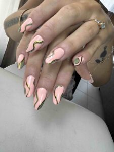 Manucure graphique rose et vert sauge, lignes abstraites or sur ongles amande, réalisée chez Sillam Nails à Villeurbanne